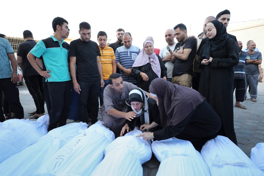 Palestinians mourn their relatives killed in the Israeli bombardment on the Gaza Strip, at Al Aqsa hospital in Deir el-Balah, Friday, Oct. 20, 2023. (AP Photo/Ali Mahmoud)