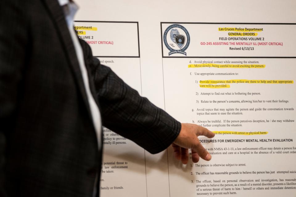 Attorney Sam Bregman points to a line in a Las Cruces Police Department field operations volume about assisting the mentally ill that says, "Do not threaten the person with arrest or physical harm," during a news conference at the Hilton Garden Inn Las Cruces on Thursday, May 12, 2022.