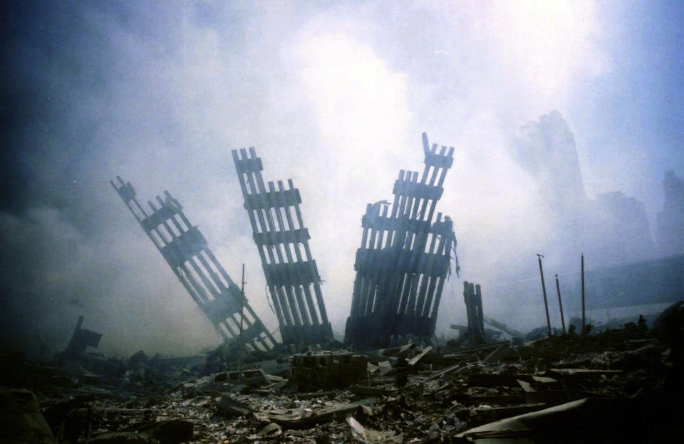 <p>The remains of the World Trade Center stands amid the debris in New York, Tuesday, Sept. 11, 2001. (AP Photo/Alexandre Fuchs)</p> 