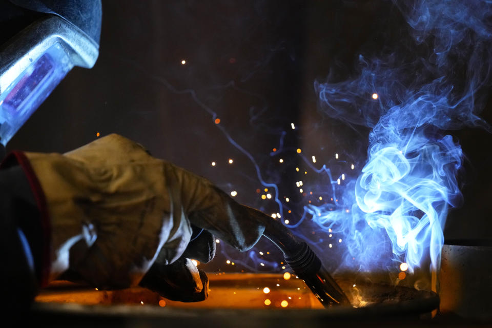 A volunteer welds a heating stove from old car rims in workshop in Siauliai, some 230 km (144 miles) north-west of the capital Vilnius, Lithuania, Thursday, Feb. 2, 2023. Since Russia invaded Ukraine last February, Lithuania, Latvia and Estonia — three states on NATO’s eastern flank scarred by decades of Soviet-era occupation — have been among the top donors to Kyiv. (AP Photo/Sergei Grits)