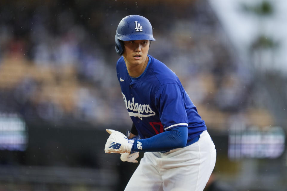 Los Angeles Dodgers designated hitter Shohei Ohtani returns to first base during the second inning of a spring training baseball game in Los Angeles, Sunday, March 24, 2024. (AP Photo/Ashley Landis)