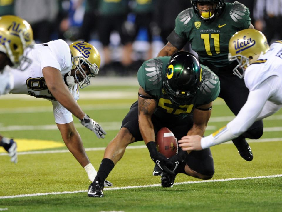 EUGENE, OR - DECEMBER 02 : Linebacker Dewitt Stuckey #52 of the Oregon Ducks recovers a fumble in the first quarter of the Pac-12 Championship game against the UCLA Bruins at Autzen Stadium on December 2, 2011 in Eugene, Oregon. (Photo by Steve Dykes/Getty Images)