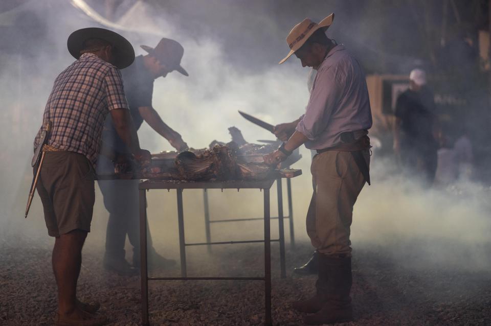 Gauchos prepare lamb for their fellow horsemen who have gathered at the Rural Association building ahead of their official participation in the inaugural festivities for President-elect Luis Lacalle Pou, in Montevideo, Uruguay, Saturday, Feb. 29, 2020. Lacalle Pou, a 46-year-old lawyer and a former senator, will be sworn-in as the country's new president on Sunday. (AP Photo/Matilde Campodonico)