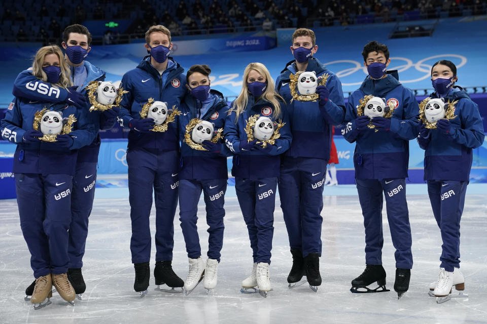 Silver medalists Team United States stand pose for a group photo following the victory ceremony after the team event in the figure skating competition at the 2022 Winter Olympics, Monday, Feb. 7, 2022, in Beijing. (AP Photo/David J. Phillip)