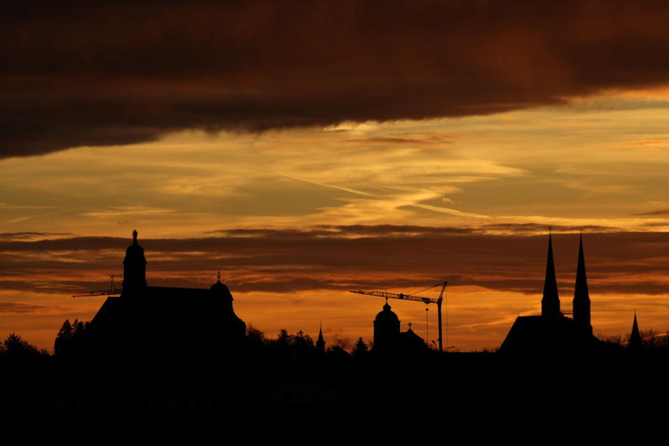 The St. Anna basilica is silhouetted by the rising sun in Altoetting near Marktl, the birthplace of of Pope emeritus Benedict XVI, Germany, Thursday, Dec. 29, 2022. The health of Pope Emeritus Benedict XVI has worsened due to his age, and doctors are constantly monitoring the 95-year-old's condition, the Vatican said Wednesday.(AP Photo/Matthias Schrader)