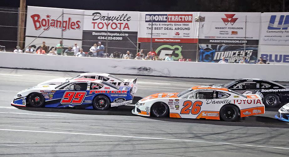 Peyton Sellers (26) follows Layne Riggs (99) as they attempt to pass Chris Denny (2, partially hidden behind Riggs‘ car) during the second race of twin 65-lap NASCAR Advance Auto Parts Weekly Series Late Model Stock Car Division races that highlighted the Halifax County Farm Bureau Championship Night event at South Boston Speedway on Sept. 4. (Joe Chandler/South Boston Speedway)