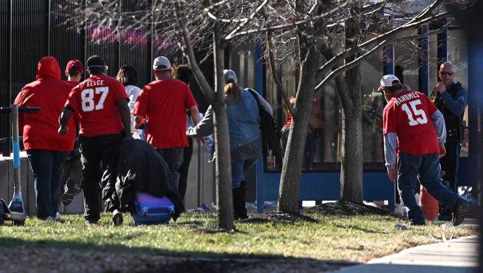 People run for cover after a shooting following the Kansas City Chiefs Super Bowl LVIII victory parade on Wednesday, Feb. 14, 2024, in Kansas City.