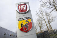 Logos of car companies are seen on the facade of the building housing the Stellantis headquarters in Lijnden, near Amsterdam, Netherlands, Monday, Jan. 18, 2021. Stellantis, the car company combining PSA Peugeot and Fiat Chrysler, was launched Monday on the Milan and Paris stock exchanges, giving life to the fourth-largest car company in the world. (AP Photo/Peter Dejong)