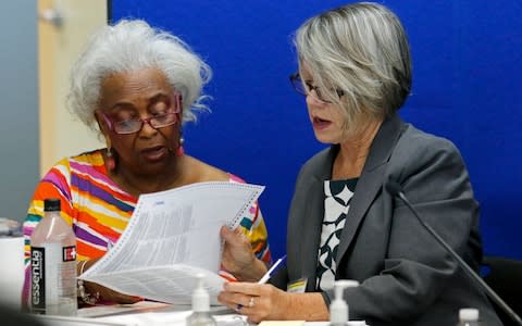 Dr. Brenda Snipes, left, Broward County Supervisor of Elections, looks at a ballot with Betsy Benson, canvasing board chair.  - Credit: AP/Joe Skipper