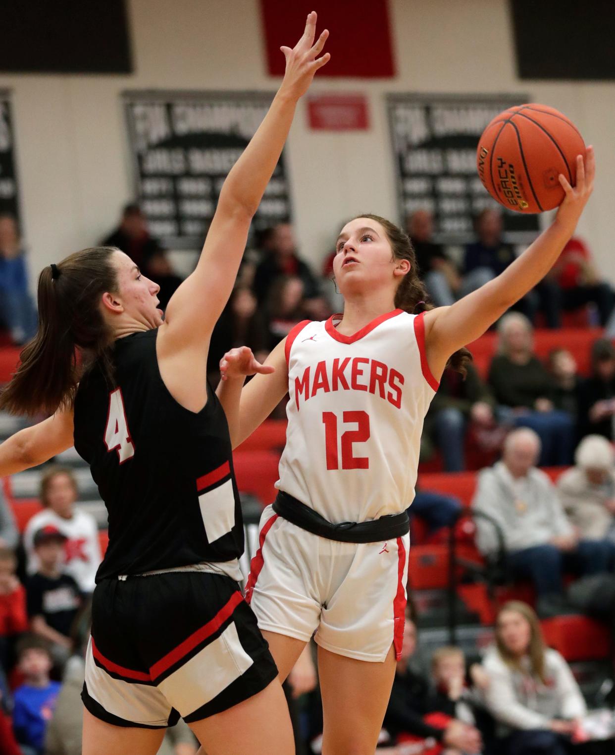 Kimberly's Kate McGinnis (12) puts up a shot against Hortonville's Rainey Welson during their girls basketball game Jan. 20 in Kimberly. McGinnis recently verbally committed to Belmont University.