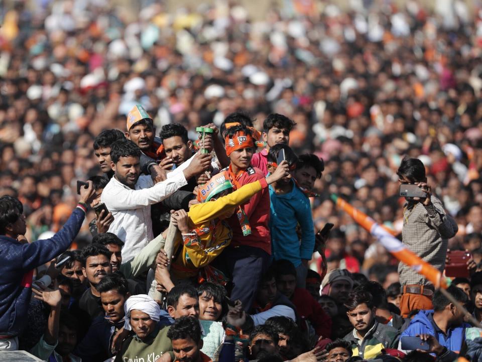 A group of people joins a huge crowd at a rally