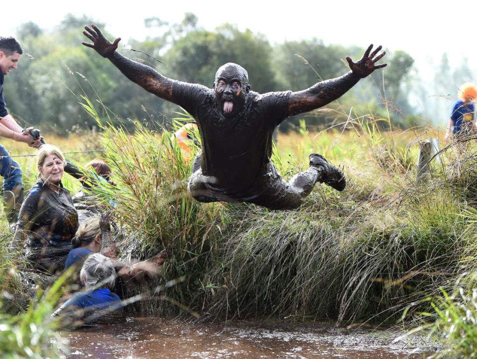 <p>Participants make their way around the course during the Mud Madness event on Sept. 25, 2016 in Portadown, Northern Ireland. The charity run in aid of Action Cancer sees over a thousand participants make their way across fields, rivers, bogs, mud holes and obstacles deep in the Northern Ireland countryside. (Charles McQuillan/McVities Mud Madness via Getty Images)</p>