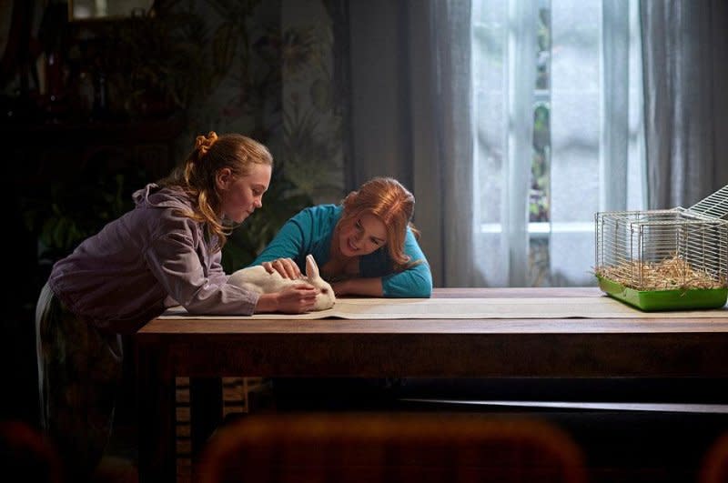 Mary (Isla Fisher, R) helps Emma (Ariel Donoghue) with her homework. Photo courtesy of Peacock