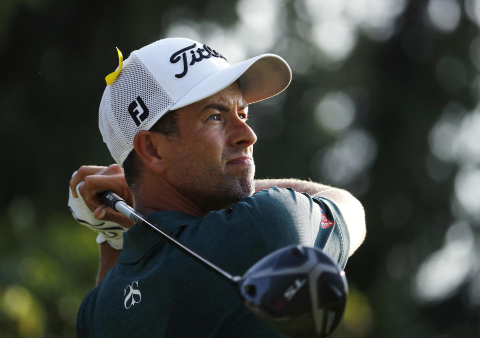 Adam Scott, of Australia, watches his tee shot on the 18th hole during the third round of the PGA Championship golf tournament at Bellerive Country Club, Saturday, Aug. 11, 2018, in St. Louis. (AP Photo/Charlie Riedel)