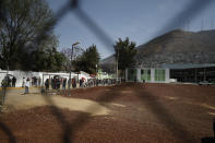 Residents wait in line for a chance to try out a new public transit system dubbed the Cablebus, outside the Campos Revolucion station in the Cuautepec neighborhood of northern Mexico City, Thursday, March 4, 2021. For the residents of Cuautepec, this new system, the first of four planned lines, will turn a commute to the nearest subway station, that can last up to two hours, into a 30-minute ride. (AP Photo/Rebecca Blackwell)