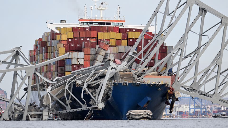 The steel frame of the Francis Scott Key Bridge sits on top of the container ship Dali after the bridge collapsed on Tuesday. - Jim Watson/AFP/Getty Images