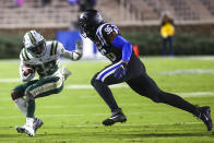 Charlotte wide receiver Micaleous Elder (23) runs with the ball while Duke defensive end Chris Rumph II (96) chases him during an NCAA college football game Saturday, Oct. 31, 2020, in Durham, N.C. (Jaylynn Nash/Pool Photo via AP)