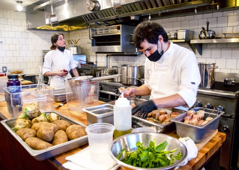 LOS ANGELES, CA - DECEMBER 23, 2021: Chef Will Aghajanian preps food before dinner service at Horses restaurant on December 23, 2021 in Los Angeles, California.(Gina Ferazzi / Los Angeles Times)