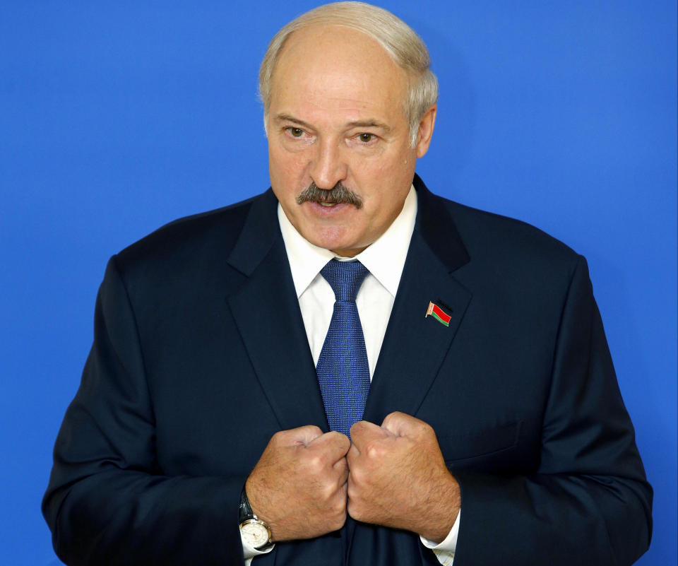 FILE - In this Sunday, Oct. 11, 2015, file photo Belarusian President Alexander Lukashenko speaks to the media at a polling station after voting during the presidential election in Minsk, Belarus. Belarus’ authoritarian President Alexander Lukashenko faces a perfect storm as he seeks a sixth term in the election held Sunday, Aug. 9, 2020 after 26 years in office. (AP Photo/Sergei Grits, File)