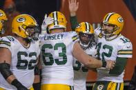 Green Bay Packers' Aaron Jones is congratulated by Aaron Rodgers and Corey Linsley after riunning for a touchdown during the second half of an NFL football game against the Chicago Bears Sunday, Jan. 3, 2021, in Chicago. (AP Photo/Nam Y. Huh)