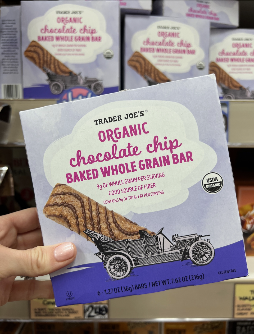 Hand holding a box of Trader Joe's Organic Chocolate Chip Baked Whole Grain Bar.