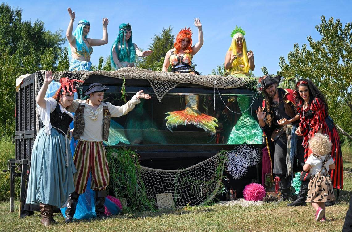 Character actors from The Storybook Forest gather in and around the company’s portable mermaid tank during the taping of a promotional video.
