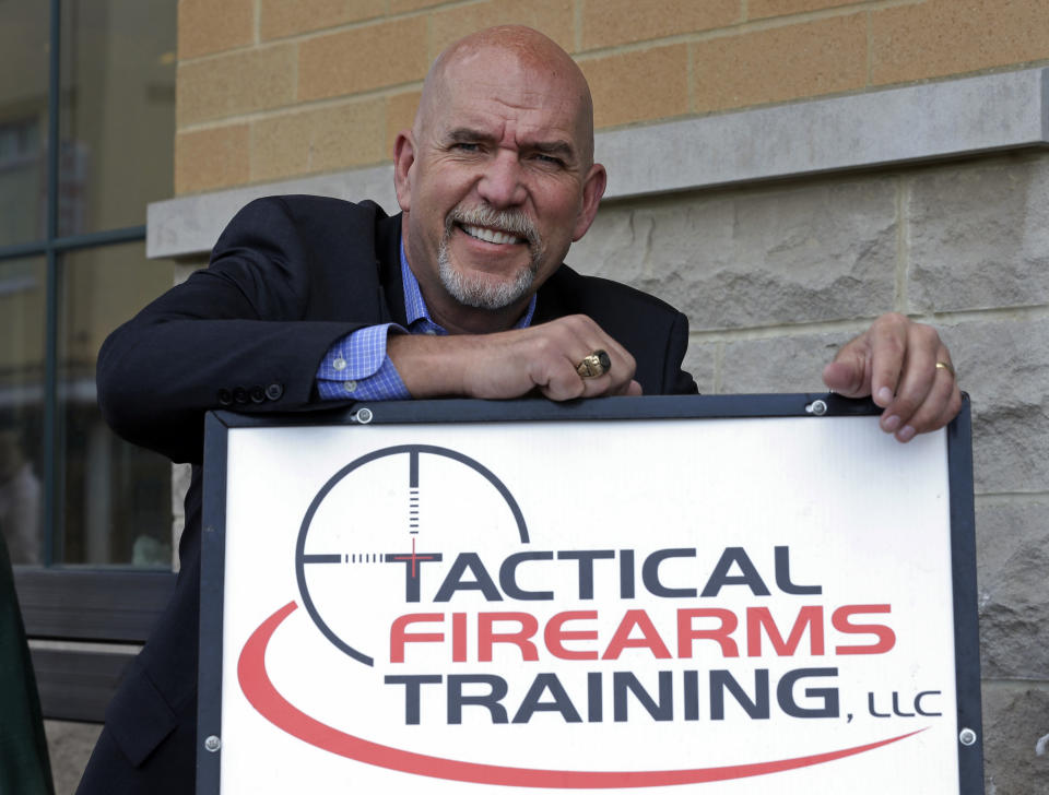 In this photo taken on Friday, April 18, 2014, Guy Relford, an attorney specializing in gun rights, poses outside his law office in Carmel, Ind. Redford is also the owner and instructor at Tactical Firearms Training teaching firearm safety as well as a comprehensive Indiana gun law course. (AP Photo/Michael Conroy)