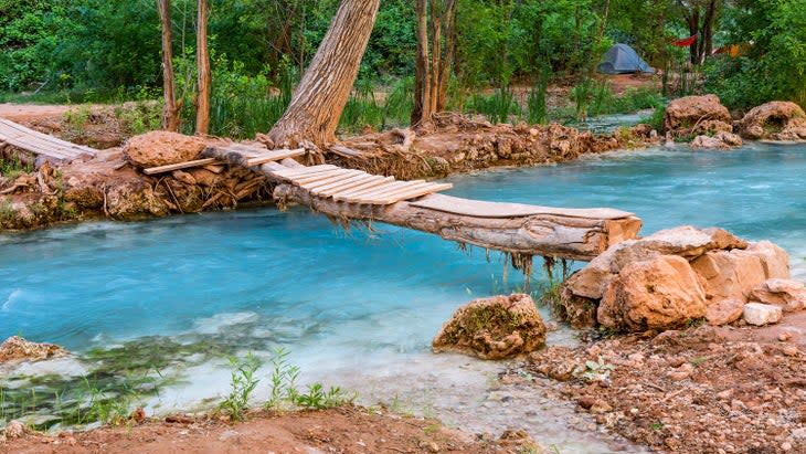 A wooden footbridge crosses Havasu Creek in the campground on the Havasupai Indian Reservation in the Grand Canyon.