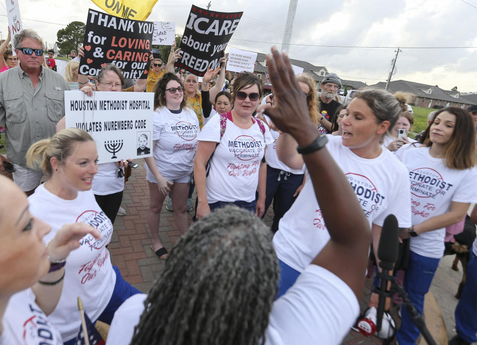 People gather to protest Houston Methodist Hospital system's rule of firing any employee who is not immunized by Monday, June 7, 2021, at Houston Methodist Baytown Hospital in Baytown, Texas. Houston Methodist staff who have refused the COVID-19 vaccine so far and their supporters participated in a gathering and march. (Yi-Chin Lee/Houston Chronicle via AP)