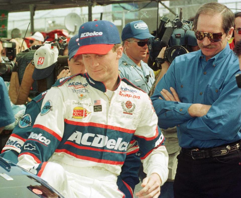 Dale Earnhardt Jr. climbs into a race car in 1998, closely watched by his father. Dale Earnhardt Sr. died in 2001 during a last-lap crash at the Daytona 500. Dale Earnhardt Jr. will be inducted into the NASCAR Hall of Fame in Charlotte Friday night.