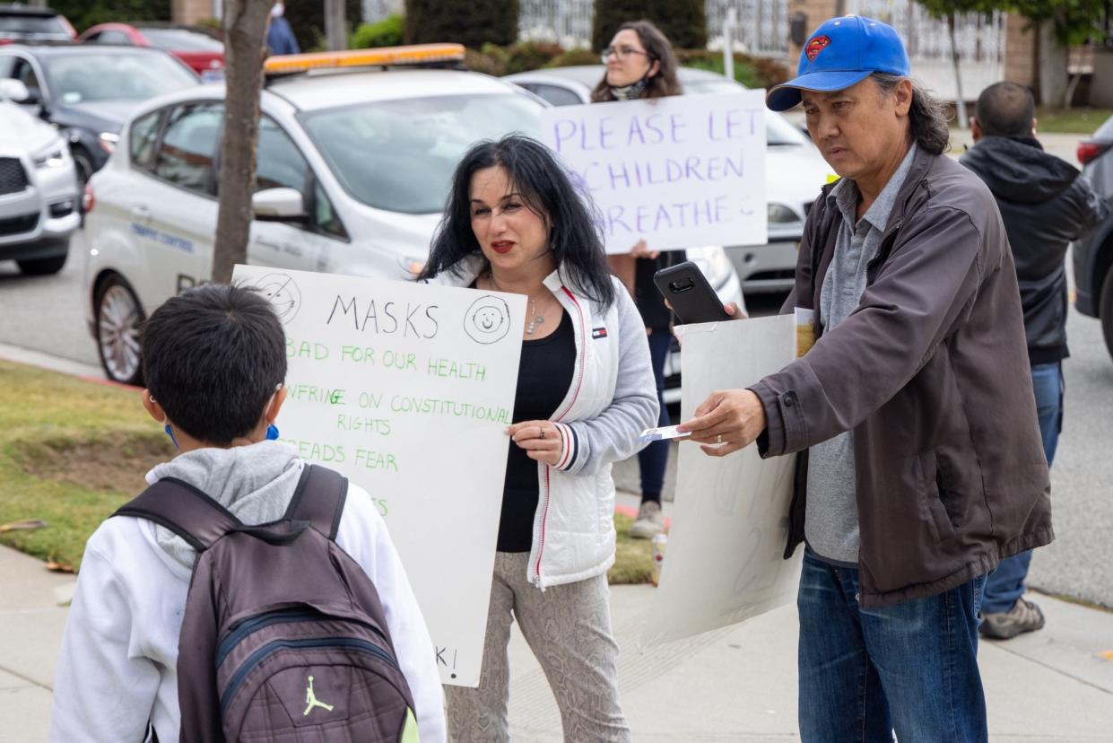 <p>A photo posted on Twitter by journalist Samuel Braslow showing anti-mask protesters outside Hawthorne Elementary School in Beverly Hills on Wednesday</p> (Twitter/)