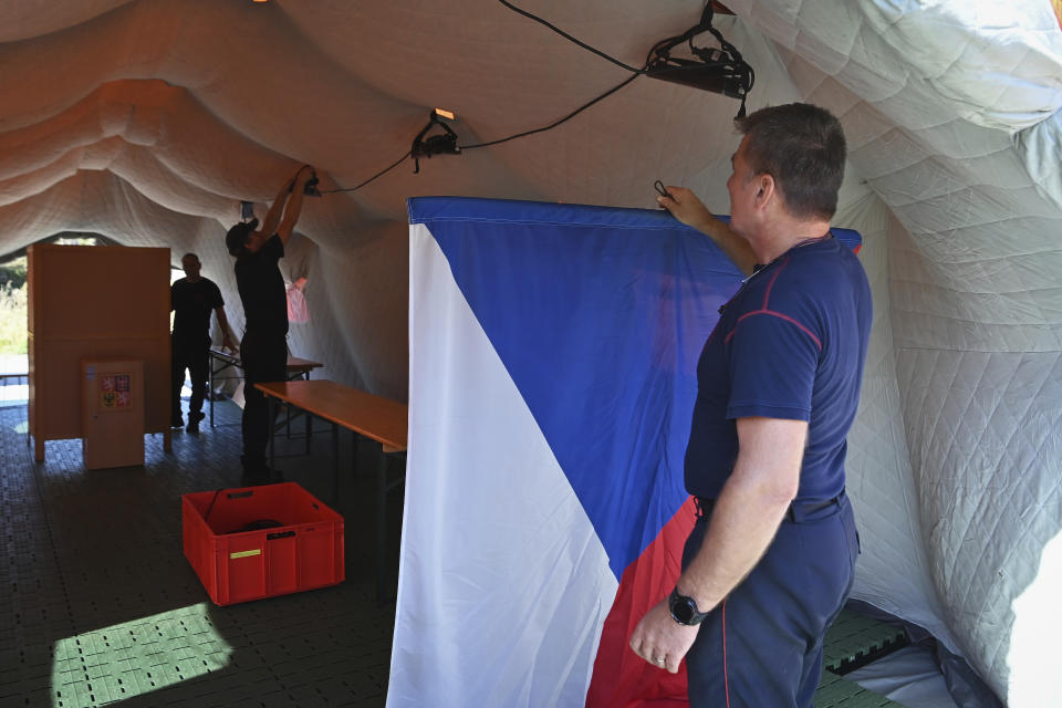 Firefighters set up an improvised polling station for a two-day vote for one-third of the seats in Parliament’s upper house, the Senate, and to select their representatives in regional elections, in ?iroká Niva, Czech Republic, Friday, Sept. 20, 2024. (Jaroslav Ozana/CTK via AP)