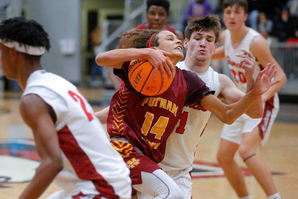 Putnam City North's Zander Baker goes past Mustang's Kaden Bogard during the boys championship game of the Cornerstone Holiday Classic basketball game between Mustang and Putnam City North in Mustang, Okla., Wednesday, Dec. 29, 2021. 