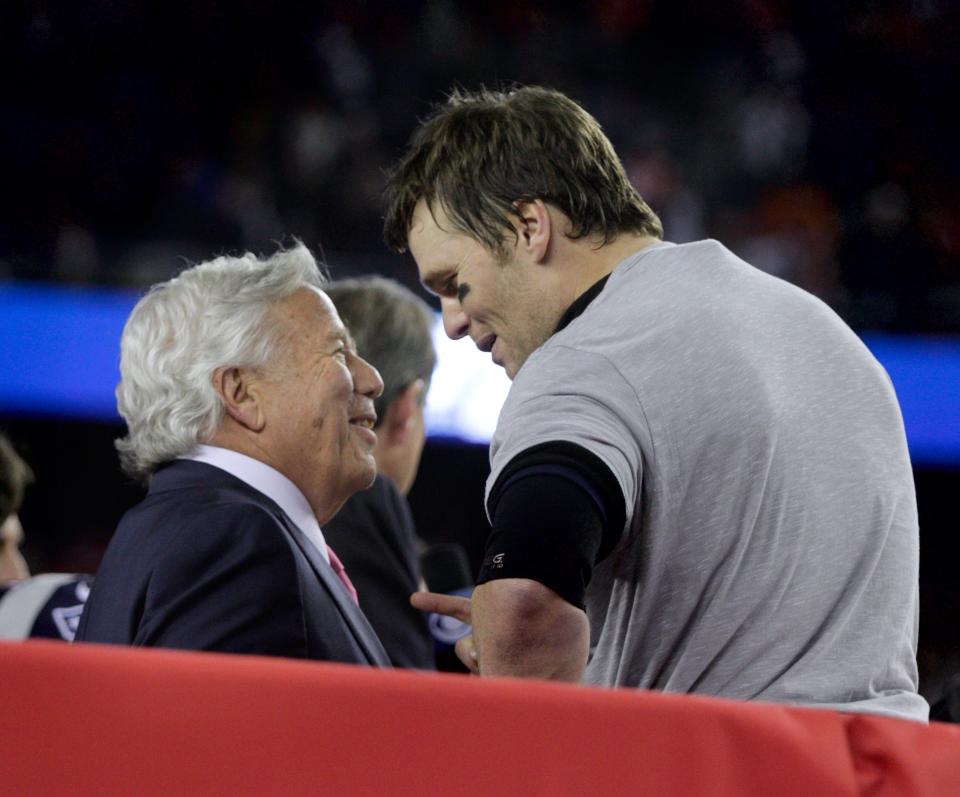 Patriots owner Robert Kraft and Tom Brady converse on the staging before awarded the AFC championship trophy in 2017. Brady is back in town this weekend for a halftime ceremony during the Patriots opener on Sunday.