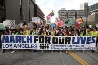 <p>People walk with signs during “March for Our Lives”, an organized demonstration to end gun violence, in downtown Los Angeles, California, U.S., March 24, 2018. (Patrick T. Fallon/Reuters) </p>