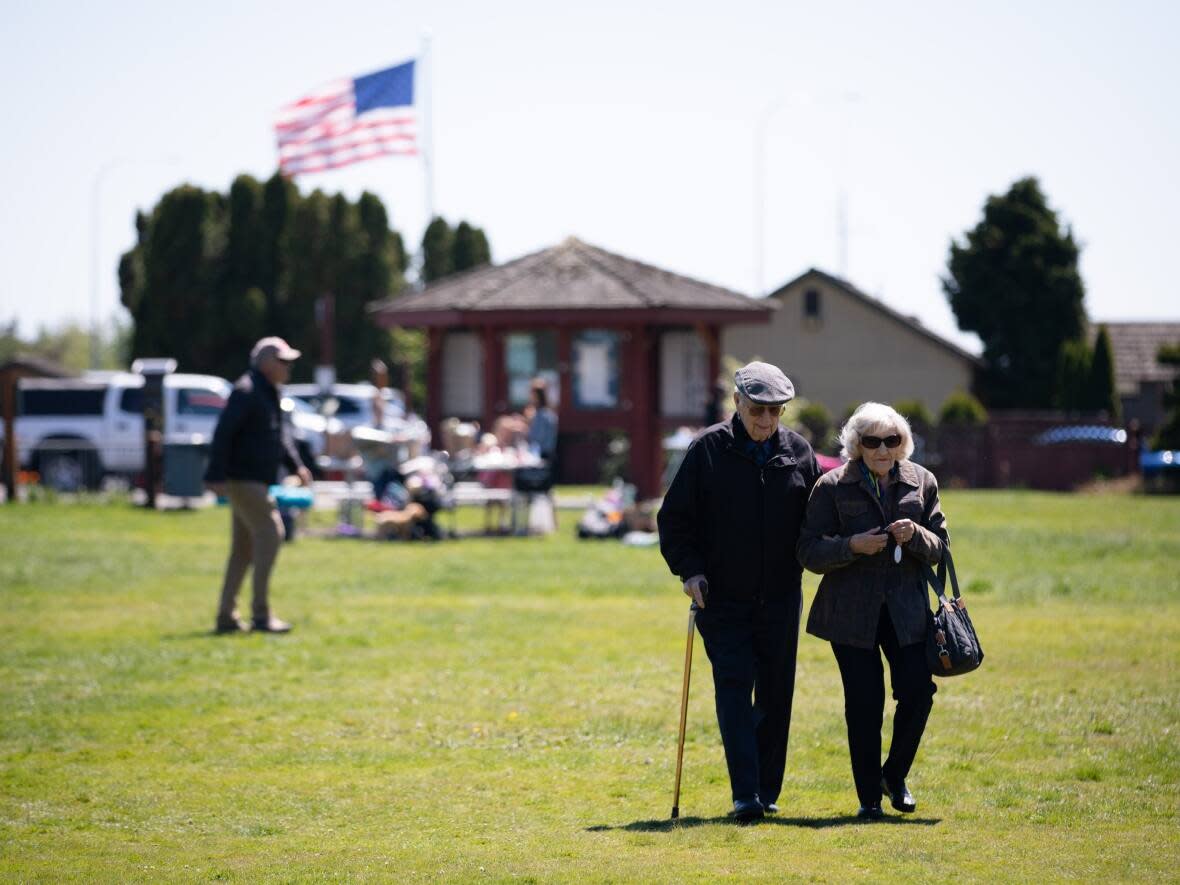 An elderly couple visits Peace Arch Park to see Canadian family members at the border with Surrey, B.C., on Friday, May 21, 2021.  (Maggie MacPherson/CBC - image credit)