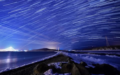 The Geminids meteor shower over Egersheld Cape on Russky Island in the Sea of Japan - Credit:  Yuri Smityuk