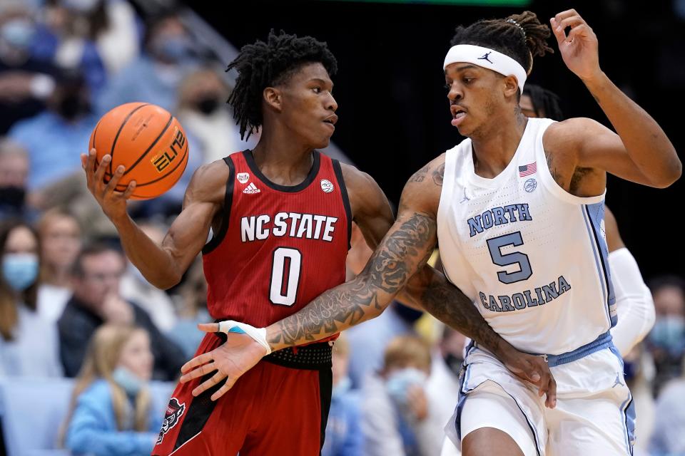 North Carolina forward Armando Bacot, right, defends against N.C. State guard Terquavion Smith during Saturday’s game.