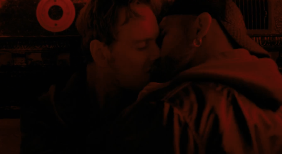Michael Fassbender's character kissing another guy in the back of a club