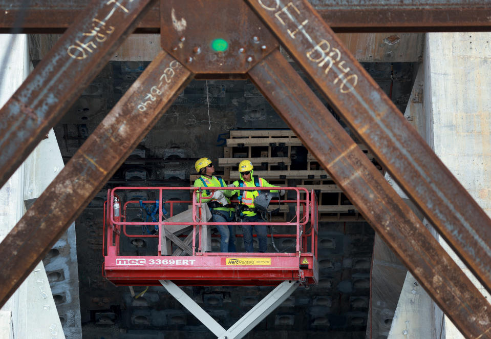 MIAMI, FLORIDA - JANUARY 05: Construction workers help build the “Signature Bridge