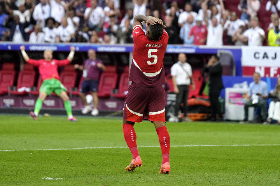 Switzerland's Manuel Akanji reacts after missing to score by penalty during a quarterfinal match between England and Switzerland at the Euro 2024 soccer tournament in Duesseldorf, Germany, Saturday, July 6, 2024. (AP Photo/Darko Vojinovic)