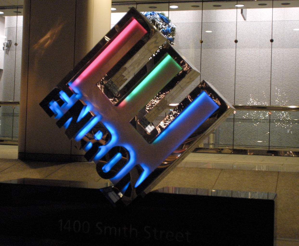 397913 07: A logo glows in front of the new corporate headquarters of the Houston-based energy trading firm Enron November 29, 2001 in Houston, Texas. The energy giant, which at one point handled some one-fifth of all US natural gas and electricity trade, is on the verge of bankruptcy after Dynery Inc. called off its proposed deal to buy Enron on November 28. (Photo by James Nielsen/Getty Images)