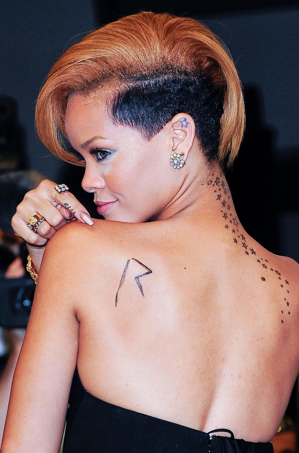 Rihanna poses with her tattoos in 2009