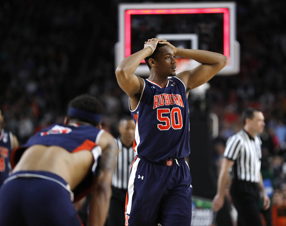 Auburn center Austin Wiley reacts at the end of a semifinal round game against Virginia in the Final Four NCAA college basketball tournament, Saturday, April 6, 2019, in Minneapolis. (AP Photo/Charlie Neibergall)