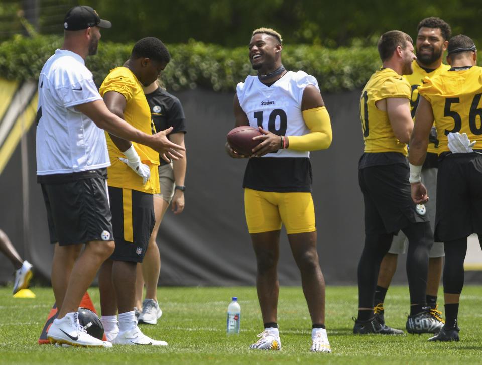 Pittsburgh Steelers wide receiver Juju Smith-Schuster (19) jokes with quarterback Ben Roethlisberger, left, during the NFL football team's training camp in Pittsburgh on Friday, July 23, 2021. (Steve Mellon/Pittsburgh Post-Gazette via AP)