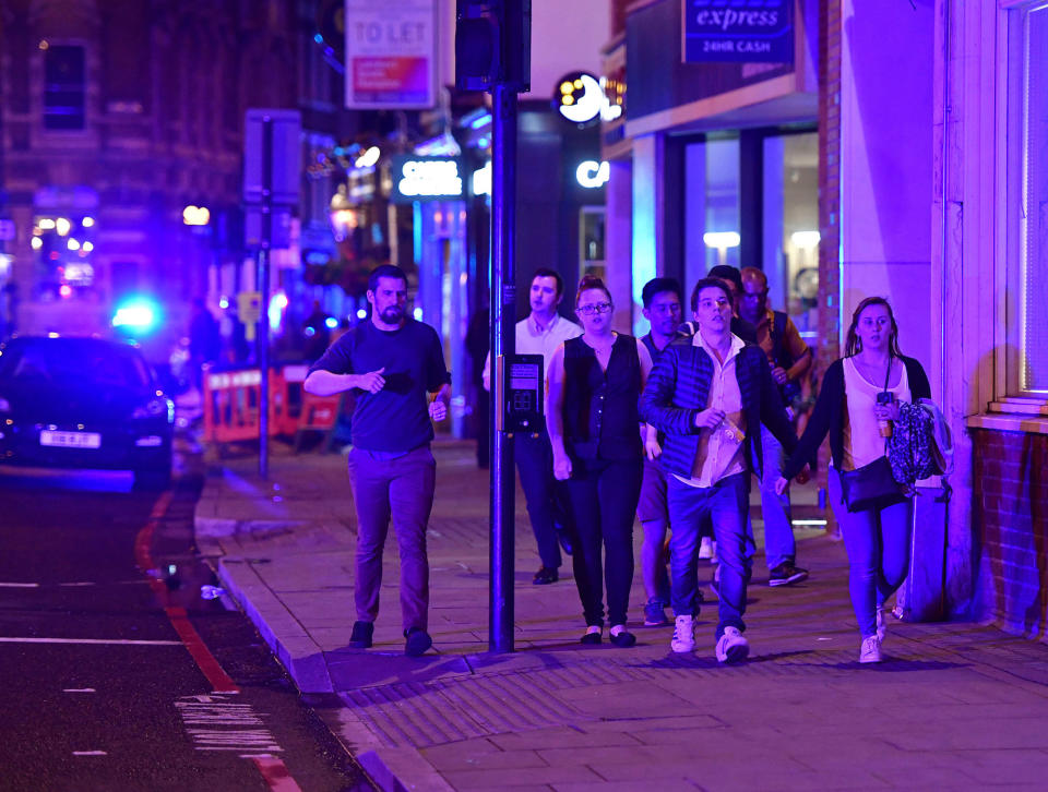 <p>People run down Borough High Street as police are dealing with a “major incident” at London Bridge in London, Saturday, June 3, 2017. (Dominic Lipinski/PA via AP) </p>