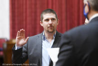 FILE - In this image provided by the West Virginia Legislative Photography, Derrick Evans is shown during his swearing-in ceremony to the West Virginia House of Delegates on Dec. 1, 2020, in Charleston, W.Va. Evans resigned after he joined the mob that stormed the U.S. Capitol on Jan. 6, 2021. Evans served three months in federal prison for his participation and is running for a U.S. House seat on Tuesday, May 14, 2024, in the West Virginia Republican primary against 1st District incumbent Rep. Carol Miller. (Will Price, West Virginia Legislative Photography via AP, File)