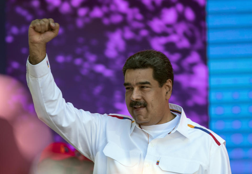 Venezuela's President Nicolas Maduro pumps his fist during a pro-government demonstration in Caracas, Venezuela, Tuesday, Feb. 12, 2019. Venezuela's opposition is calling supporters into the streets across the country in a campaign to break the military's support of President Nicolas Maduro. The demonstrations come after more than a month of pressure led by opposition lawmaker Juan Guaido, while Maduro remains firmly in power and at the military's helm. (AP Photo/Rodrigo Abd)