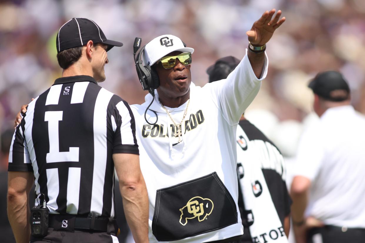 Colorado coach Deon Sanders talks to line judge Bret Bascule in the second quarter of his team's against TCU at Amon G. Carter Stadium.