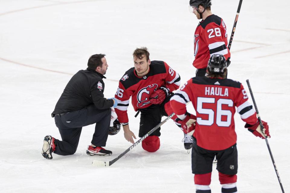 New Jersey Devils right wing Timo Meier (96) is looked at by medical staff in front of defenseman Damon Severson (28) and left wing Erik Haula (56) during the third period in game seven of the first round of the 2023 Stanley Cup Playoffs at Prudential Center.